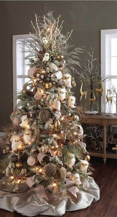 a decorated christmas tree with white and gold ornaments in the center is surrounded by other holiday decorations