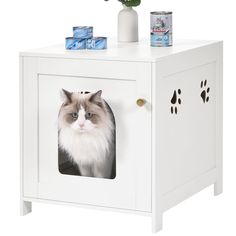 a cat sitting in a white cabinet with its paw prints on the front and side