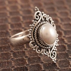 For the romantic at heart, this ring has a slightly Victorian air. Rakesh Rana in India designs the ring, which is crafted from sterling silver and set with a creamy white cultured pearl. Pearl Ring Designs Unique Silver, Ring Designs Silver, Trendy Silver Jewelry, Pearl Cocktail Ring, Pearl Rings Vintage