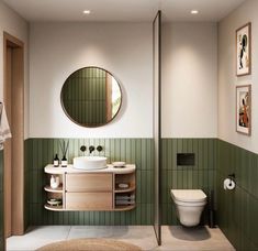 a bathroom with green tiles and white fixtures, including a round mirror above the sink