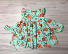 "Beautiful handmade baby girl, toddler, Girl dress is a Retro style , flutter sleeve, custom dress made from a Bright floral cotton fabric. The dress buttons in the back, it also ties in the back. All seams are finished. Sewn with great care. Boutique quality sewing. I have a size 4 ready to ship. If you need the length of the dress to be different please include a message with order. Measurements of the dress. size , length, 3 months length 12.5\". 6 months, length 14.5\". Size, Chest, Waist, L Playful Ruffle Sleeve Dress With Floral Print, Playful Floral Print Dress With Flutter Sleeves, Playful Floral Print Dress With Ruffle Sleeves, Spring Floral Print Twirl Dress With Flutter Sleeves, Spring Twirl Dress With Floral Print And Flutter Sleeves, Spring Floral Twirl Dress With Flutter Sleeves, Flowy Spring Twirl Dress With Flutter Sleeves, Cute Flowy Twirl Dress With Flutter Sleeves, Spring Flutter Sleeve Twirl Dress For Garden Party