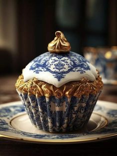 a blue and white cupcake sitting on top of a plate