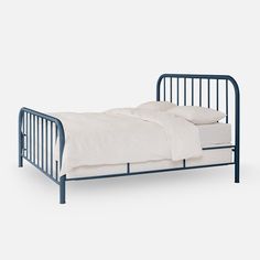 a blue metal bed frame with white sheets