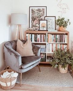 a living room filled with furniture and bookshelves next to a wall covered in pictures