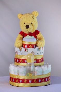 a teddy bear sitting on top of a cake