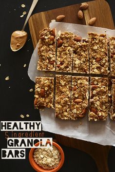 granola bars cut into squares on a cutting board