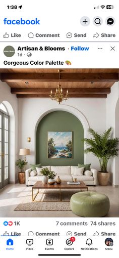 an image of a living room with green walls and white couches in the middle