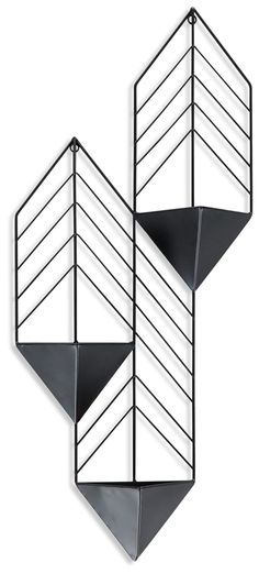 two metal shelves with black and white lines on them, one is hanging from the wall