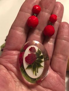 "I put a pair of faceted red glass screwback earrings made in West Germany with the pretty oval acrylic brooch featuring tiny roses and foliage. The earrings are sterling silver. The pin measures almost 1 3/4\" top to bottom and just over 1\" across. The earring dangles about 1\" top to bottom. The dangling bead is about 8-9mm. You don't have to wear the pin and the earrings at the same time . . . but you might. NO DISCOUNTS APPLY TO LISTINGS $25 AND UNDER ohio" Vintage Brooches With Matching Earrings For Gift, Vintage Oval Jewelry With Rose Design, Vintage Sterling Silver Jewelry With Rose Design, Rose Vintage Sterling Silver Jewelry, Vintage Rose Brooch Jewelry, Red Rose Design Round Jewelry, Vintage Rose Jewelry With Brooch, Red Round Brooch Jewelry, Vintage Rose Brooch