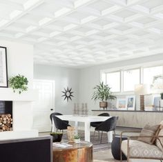 a living room filled with furniture and a fire place next to a dining room table