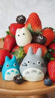 some strawberries and chocolate covered animals on a table