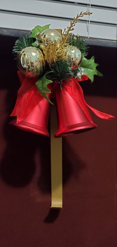 a red and gold christmas decoration with bells