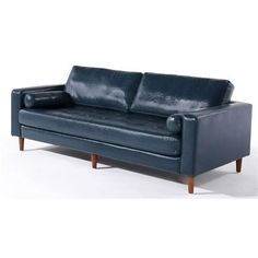 a blue leather couch sitting on top of a white floor