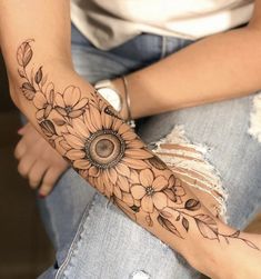 a woman's arm with flowers on it