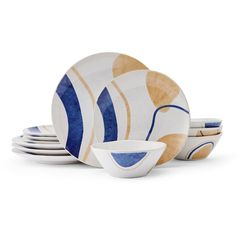 a set of four plates and bowls with blue, yellow and white designs on them