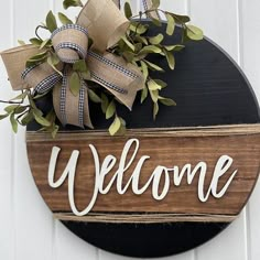 a welcome sign hanging on the side of a door