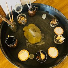 there are many bowls and spoons on the tray