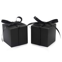 two black gift boxes with ribbons and bows