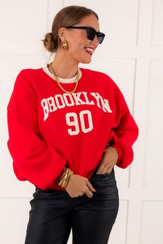 Experience ultimate comfort and style with our Brooklyn Sweatshirt. Made with a fleece interior, this sweatshirt features a rounded neckline, long sleeves, and a Brooklyn graphic on the front. Perfect for any casual occasion. Model is wearing a size Small. Runs true to size 60% Cotton, 40% Polyester Size Small Measurements Bust: 30" Length: 22" Size Large Measurements Bust: 32" Length: 23" Washing Instructions Hand wash cold separately. Do not bleach. Hang to dry. Winter College Sweatshirt With Letter Print, Oversized Red Sweater With Letter Print, College Sweater With Letter Print And Long Sleeves, Trendy Long Sleeve College Sweatshirt, Red Long Sleeve Fleece Sweatshirt, Red Crew Sweatshirt With Letter Print, Red College Sweater With Ribbed Cuffs, Trendy Campus Sweatshirt For Fall, Oversized Red Sweatshirt With Graphic Print