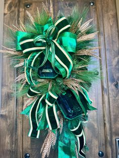 a green and gold christmas wreath on a door