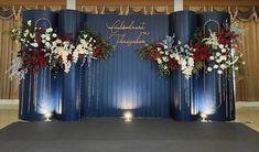 the stage is set up with flowers and candles for an elegant wedding reception in blue