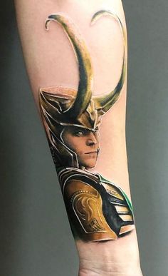 a person with a tattoo on their arm that has an image of loki in it