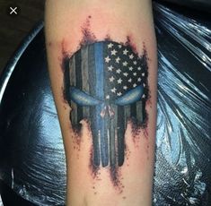 a skull with an american flag painted on it's face is shown in this tattoo