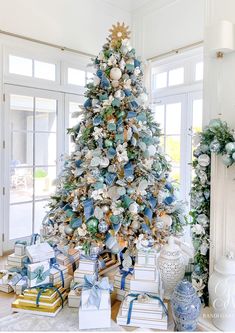 a decorated christmas tree with blue and white ornaments