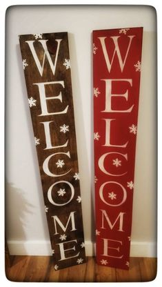 two wooden welcome signs sitting next to each other on top of a hard wood floor