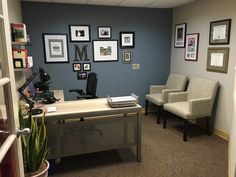 an office with chairs and pictures on the wall