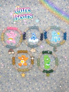 the care bears bracelets are on display in front of a rainbow - colored background