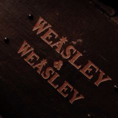 we are looking at an old wooden box that says weasely and whiskey on it