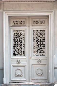 an ornate white door with intricate carvings on the front and side panels, which are decorated with