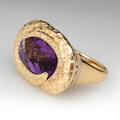 This fashionable ring is centered with an oval mixed cut amethyst weighing 8.65 carats, in a partial bezel setting. The center is surrounded by a modified halo, shared prong set with a total of thirty-two (32) round brilliant cut diamonds. The ring measures 18.6mm at the top, rises 8.7mm above the finger, tapering to 2.1mm wide and 0.9mm thick at the base of the shank. The size currently fits an 8. Luxury Purple Ring With Bezel Setting, Luxury Yellow Gold Amethyst Ring With Bezel Setting, Luxury Oval Amethyst Ring With Polished Finish, Luxury Polished Oval Amethyst Ring, Oval Amethyst Ring In Luxury Style, Eternity Band Ring, Diamond Cocktail Rings, Purple Eyes, Halo Ring