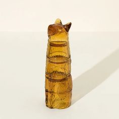 a brown glass vase sitting on top of a white table