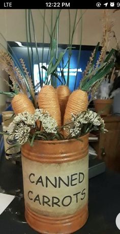 an old can with carrots in it sitting on a table