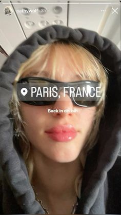 a woman wearing sunglasses with the words paris, france written on her face in front of her eyes