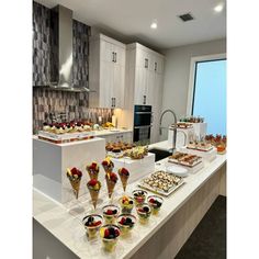 a kitchen filled with lots of food on top of a counter