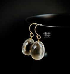 These are the ultimate everyday earrings! Just the thing to grab on the way out the door for that added sparkle and will go with everything in your wardrobe. These gems are truly amazing in person...like liquid pools of light. They are all natural, the finest specimens available, with the utmost luster and superb clarity. These 3 dimensional full egg shaped drops require the finest roughs to manufacture into these stunning beauties. As with this particular cut, the inclusions would be greatly ma Handmade Briolette Earrings For Formal Occasions, Elegant Clear Earrings As Gift, Modern Gold Briolette Earrings, Formal Clear Teardrop Earrings, Classic Clear Earrings For Gifts, Elegant Drop Earrings For Everyday, Elegant Clear Pierced Jewelry, Elegant Clear Crystal Earrings For Everyday, Elegant Teardrop Clear Earrings