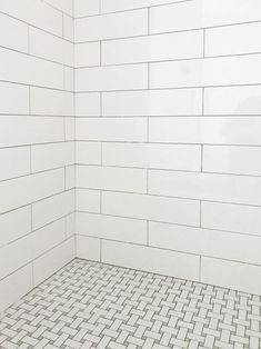 a white tiled shower stall in a bathroom