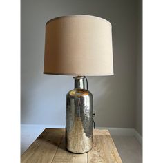 a lamp that is on top of a wooden table