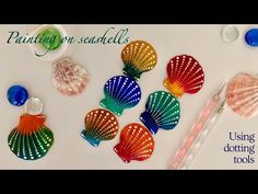 several different colored seashells sitting on top of a table