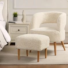 a white chair and foot stool in a bedroom