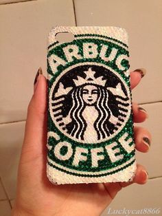 someone is holding up a phone case with the starbucks logo on it and glitters