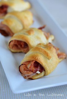 ham and cheese pastry rolls on a white plate