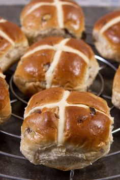 freshly baked hot cross buns cooling on a rack