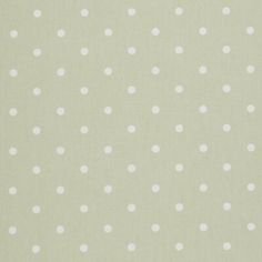 a white polka dot pattern on a light green background