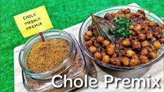 two bowls filled with different types of food on top of a wooden table next to a sign