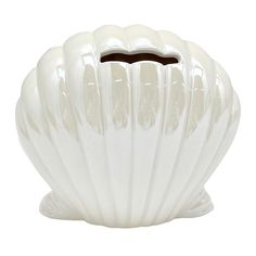 a white vase that is shaped like a shell