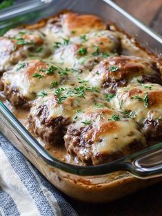 a casserole dish with meat and cheese in it on top of a wooden table